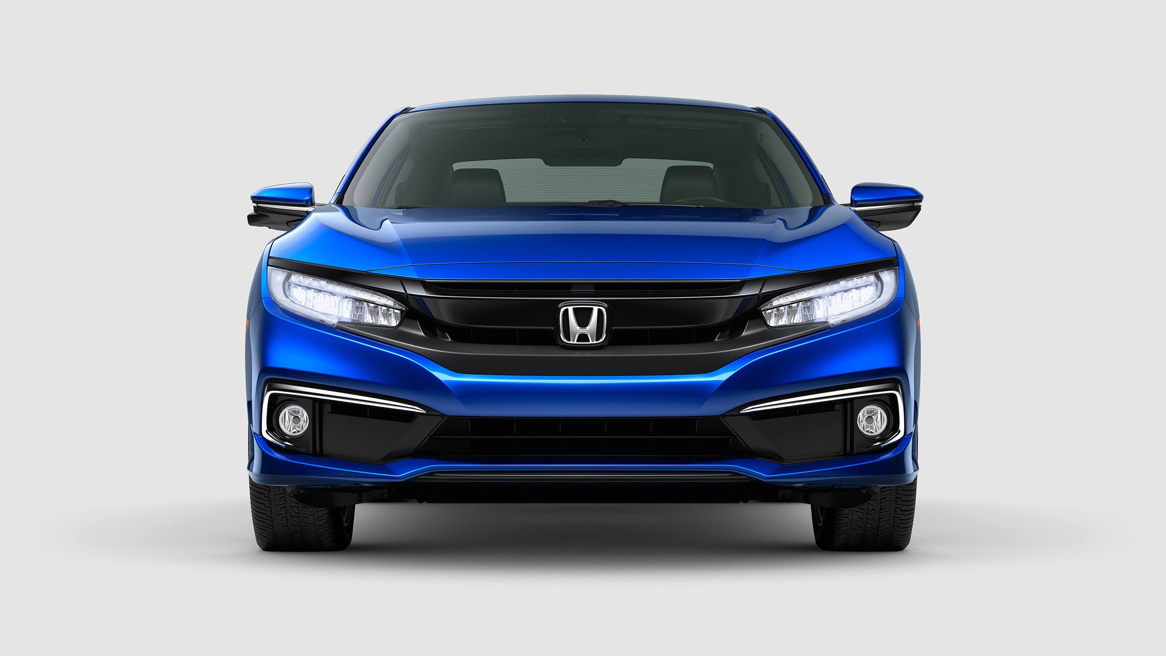 front view of the 2020 honda civic touring coupe in aegean blue